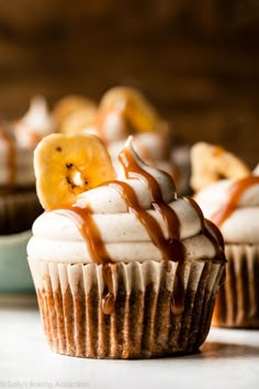 cupcakes with icing, bananas and caramel drizzle on top