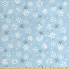 blue and white snowflakes on a light blue background, with a ruler in the foreground