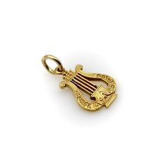 This is part of Chairish’s Fine Jewelry assortment.  This 14k gold pendant is shaped like a musical lyre and inscribed with the words “Choate Musical Clubs.” The charm is most likely associated with Choate Rosemary Hall, a boarding school founded in the 1890’s in Wallingford, Connecticut known for its rigorous academics. The initials “J.W.S.” are engraved on the back of the charm. The gold has an acid wash finish that makes the details of the lyre stand out. The charm was crafted with careful attention to detail, down to the delineation of each individual string.   The charm weighs 1.7 grams. It measures 1/2” x 3/4”.   The perfect charm for a music lover! Wallingford Connecticut, Boarding School, Music Lover, Metal Charm, Gold Charm, Acid Wash, Connecticut, Charm Jewelry, Rosemary