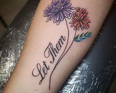 a woman's arm with flowers on it and the word mom written in cursive writing