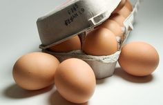 an egg carton filled with brown eggs