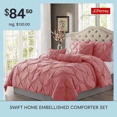 a bed with pink comforter and pillows on it for $ 84 50 reg $ 350 00