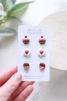 a pair of strawberry cupcake earrings on a card