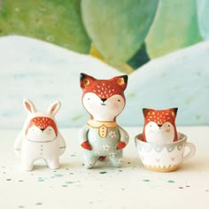 three little figurines sitting next to each other