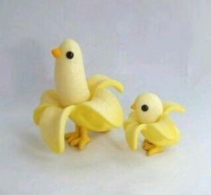 two small plastic yellow birds sitting next to each other