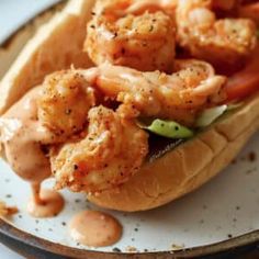 there is a sandwich with shrimp and sauce on it