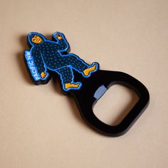 a bottle opener with a blue monkey on it