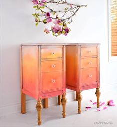 two wooden drawers with pink flowers on the top and bottom, against a white wall