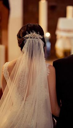 the back of a bride's veil as she walks down the aisle