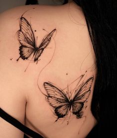 two butterflies on the back of a woman's shoulder