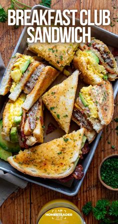 breakfast club sandwich on a tray with avocado and mustard in the bowl next to it