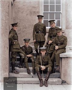 a group of men in uniforms sitting on steps