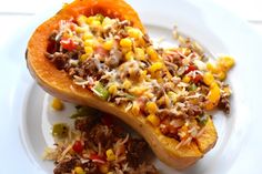 a white plate topped with two stuffed sweet potatoes