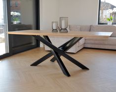 a living room with a couch, coffee table and glass vases on the floor