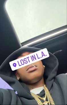 a person wearing a hoodie with the word lost in l a written on it