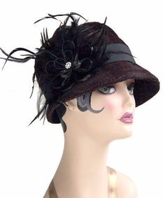 THE GRACE, handmade in Seattle, WA, USA, is a soft and flexible, 1920s style cloche hat. This hat is shown in Bongo Black/Gray Upholstery Fabric with assorted bands and trims. The brim is 2" at center front, flaring out to 2 3/4" at side front, and curving back to 3/4" at center back of hat. The crown is made of six panels. Prices are as shown. May be ordered without band for $79. These hats are custom made and all sales are final. Available in Medium 22-1/2 " and Large 23-1/2 " with custom sizi Elegant Black Bucket Hat, Gatsby Style Wide Brim Adjustable Hats, Elegant Black Bucket Hat With Short Brim, Fitted Flapper Cloche Hat With Brim, Adjustable Wide Brim Flapper Hat, Gatsby Style Short Brim Cloche Hat For Party, Fitted Flapper Cloche Hat, Gatsby Style Cloche Hat With Short Brim For Party, Gatsby Style Party Cloche Hat With Short Brim