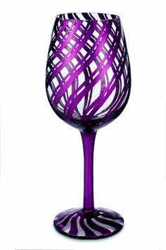 a purple wine glass sitting on top of a table