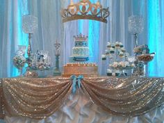 a table topped with a cake covered in frosting and surrounded by other desserts