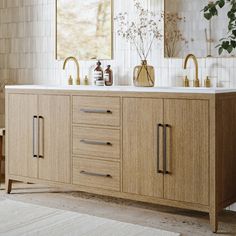 a bathroom vanity with two sinks and mirrors