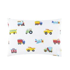 a white pillow with colorful trucks and planes printed on the front, along with a blue sky background