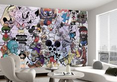 a living room filled with white furniture and walls covered in cartoon character wallpapers