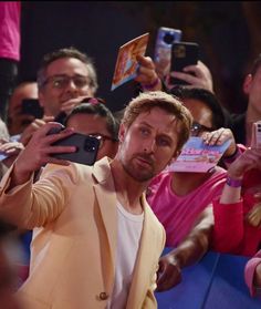 a man taking a selfie in front of a group of people