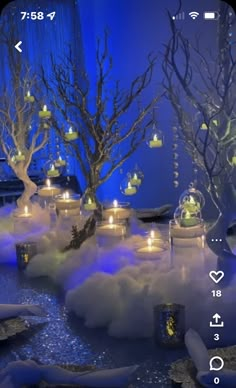 candles are lit in the middle of a winter scene