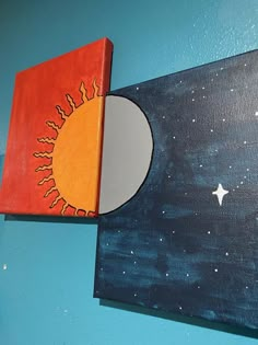 two paintings on the wall one has a sun and moon painted on it