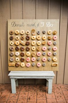 a wooden sign with doughnuts on it