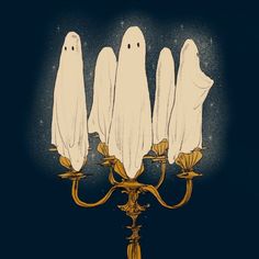 three white ghost candlesticks sitting on top of a gold candelabra