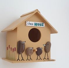 a bird house with three birds on it