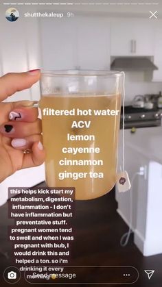 a woman holding a glass of tea in her hand with the caption, filtered hot water acv lemon cayenne cinnamon ginger tea