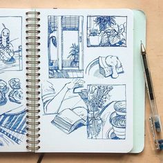 an open notebook with drawings on it next to a pen