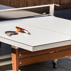 a ping pong table with two paddles on it