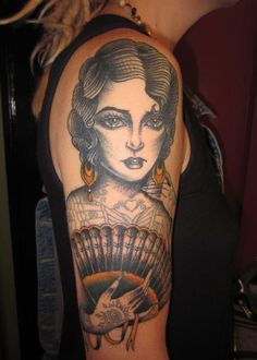 a woman with a fan tattoo on her arm