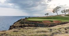 a golf course on the edge of a cliff overlooking the ocean