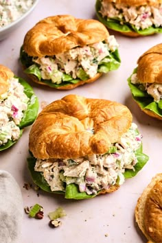 several chicken salad sandwiches on croissants with lettuce