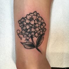 a black and white flower tattoo on the leg