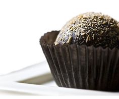 a chocolate muffin sitting on top of a white plate