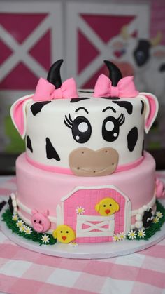 a cake decorated with a cow and farm animals