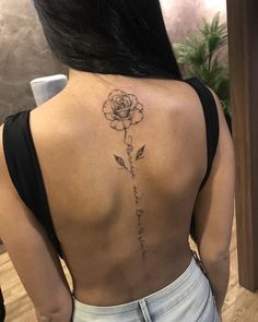 a woman with a rose tattoo on her back