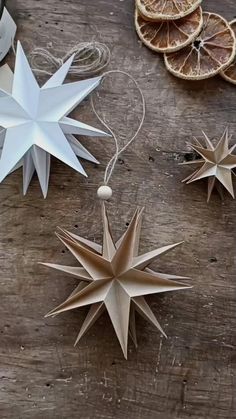 paper stars and oranges on a wooden table