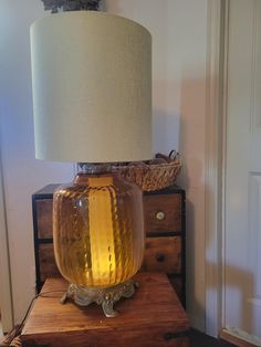 a glass lamp sitting on top of a wooden table