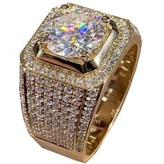 a gold ring with a large diamond surrounded by smaller round brilliant cut diamonds in the center