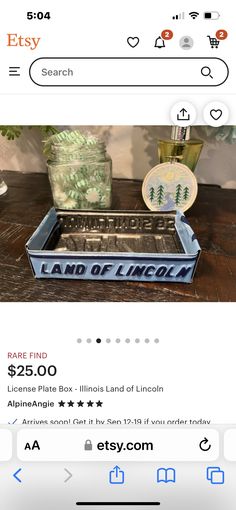 an image of a metal tray with lincoln land of lincoln on it and another item in the background