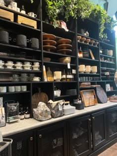 the shelves are filled with pots, pans and other kitchen items in this store