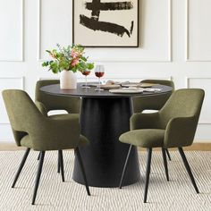 a dining table with four chairs around it