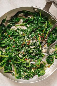 a pan filled with spinach and other vegetables