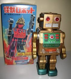 a toy robot next to a box on a table