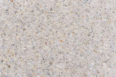 a close up view of a concrete surface with small rocks